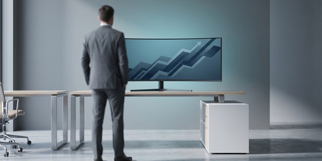 A consultant reviewing a rising performance graph on a monitor